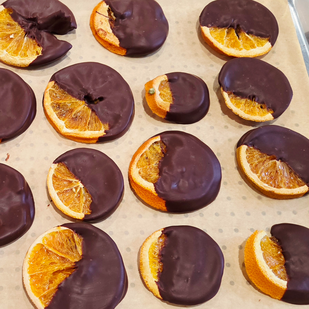 Orange slices partly dipped in chocolate