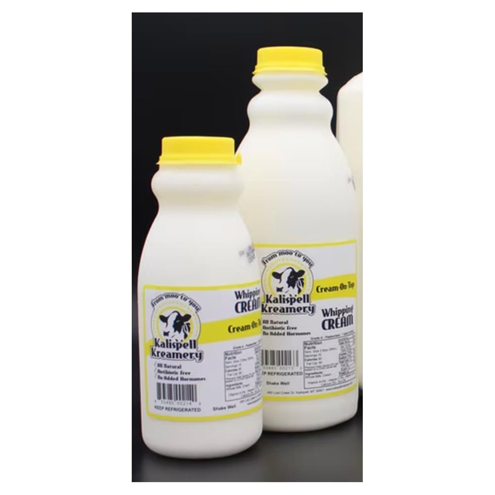 Two bottles of Kalispell Kreamery heavy whipping cream with yellow caps.