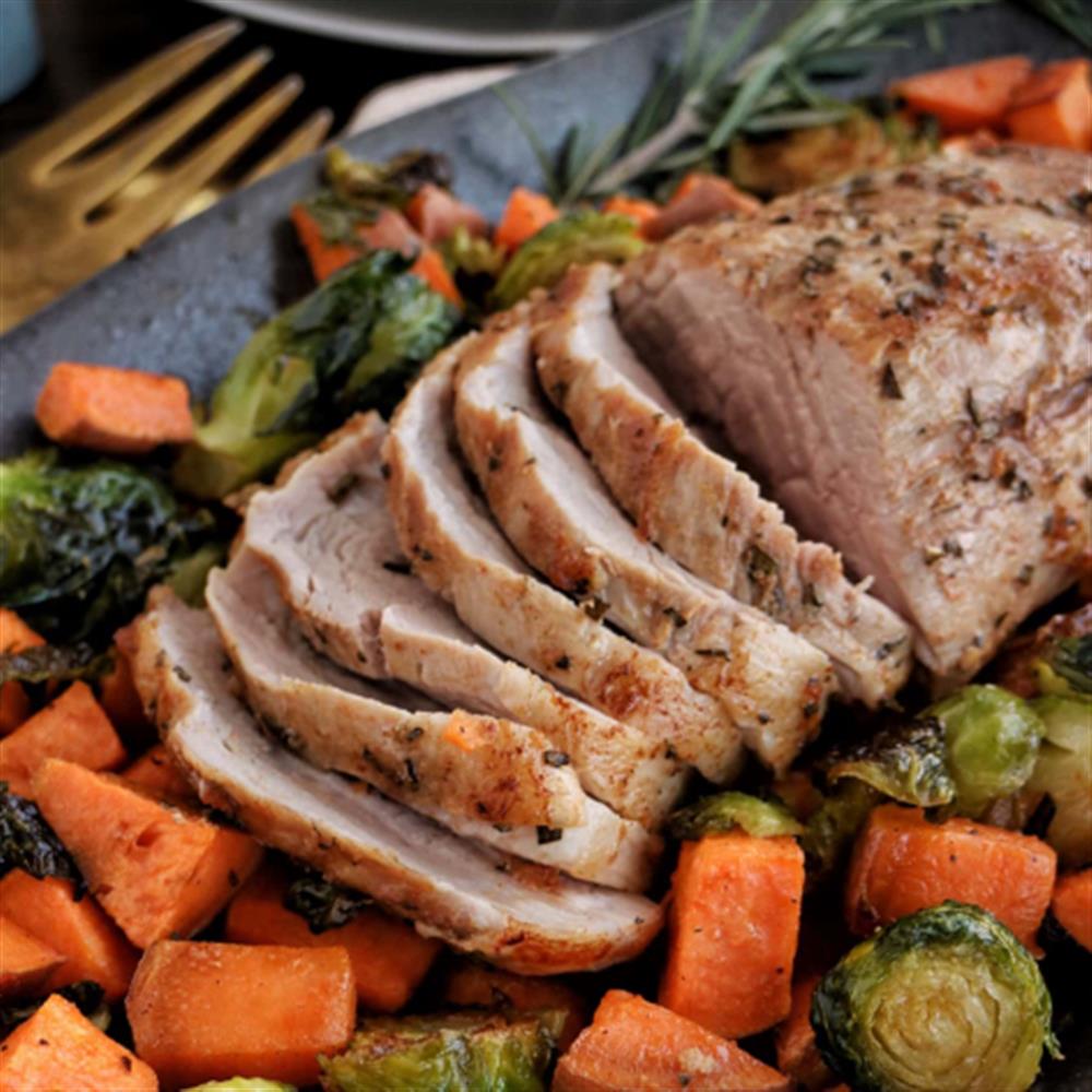Sliced cooked pork roast with vegetables
