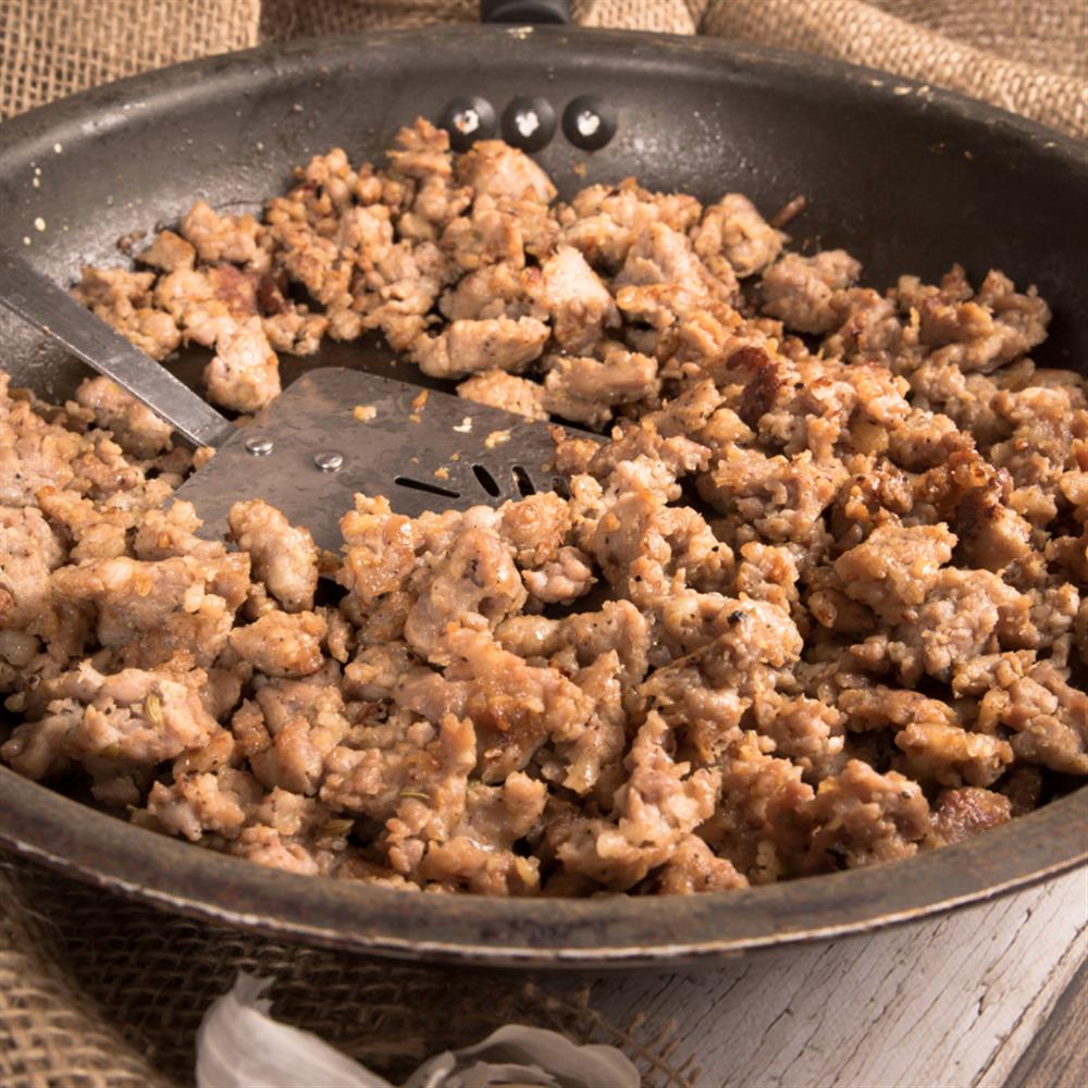 Crumbled cooked sausage in a skillet