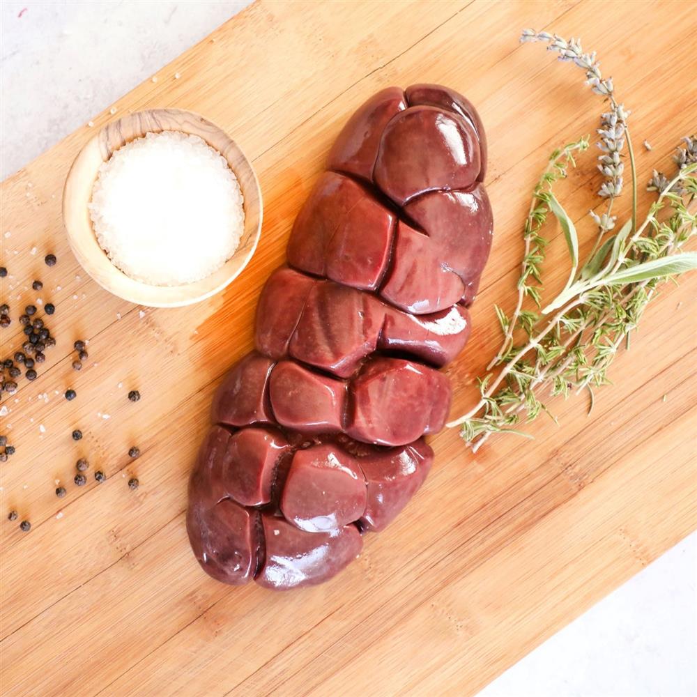 Raw beef kidney on a cutting board