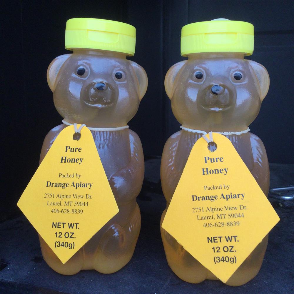 Two bear-shaped honey bottles