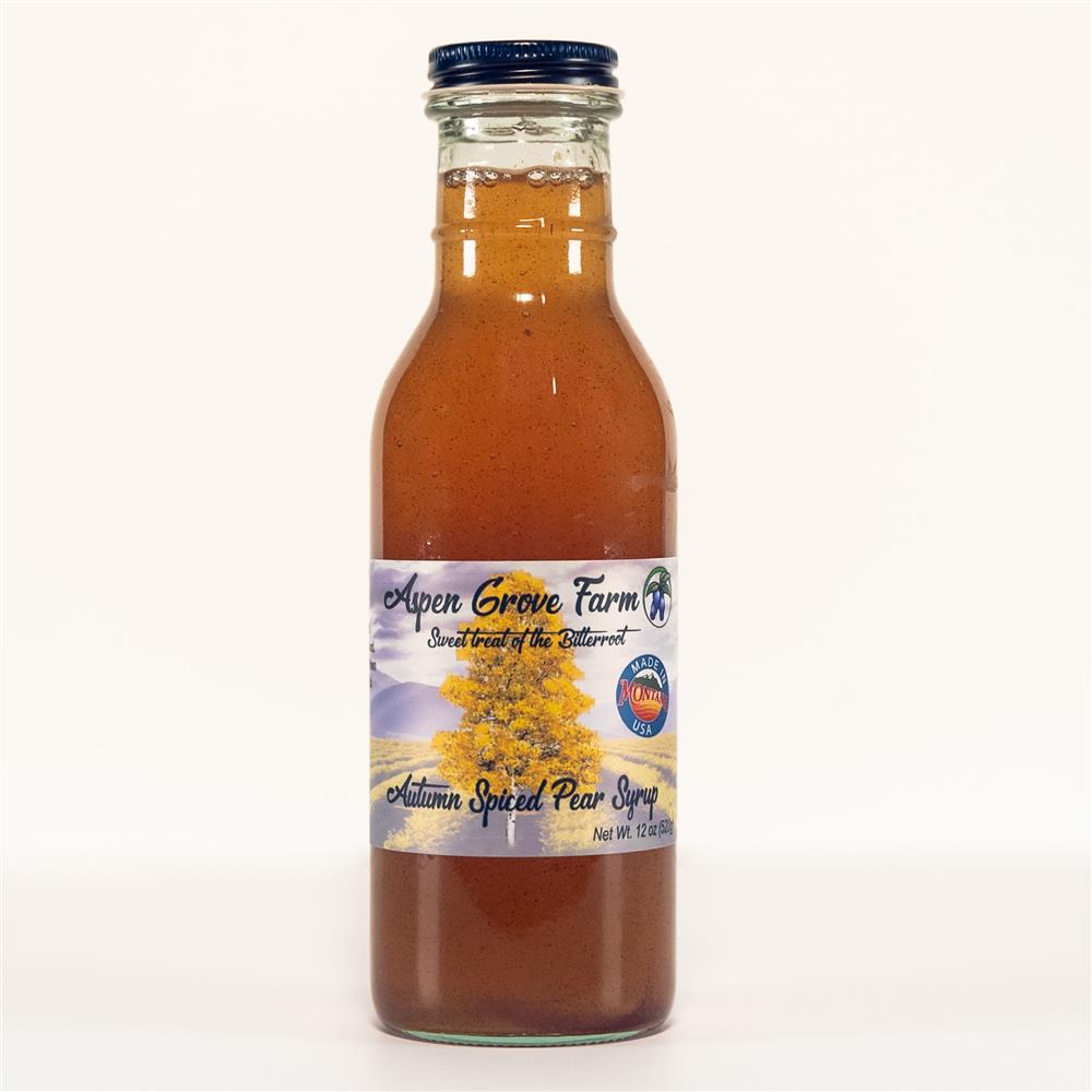 A glass bottle labeled Autumn Spice Pear Syrup.
