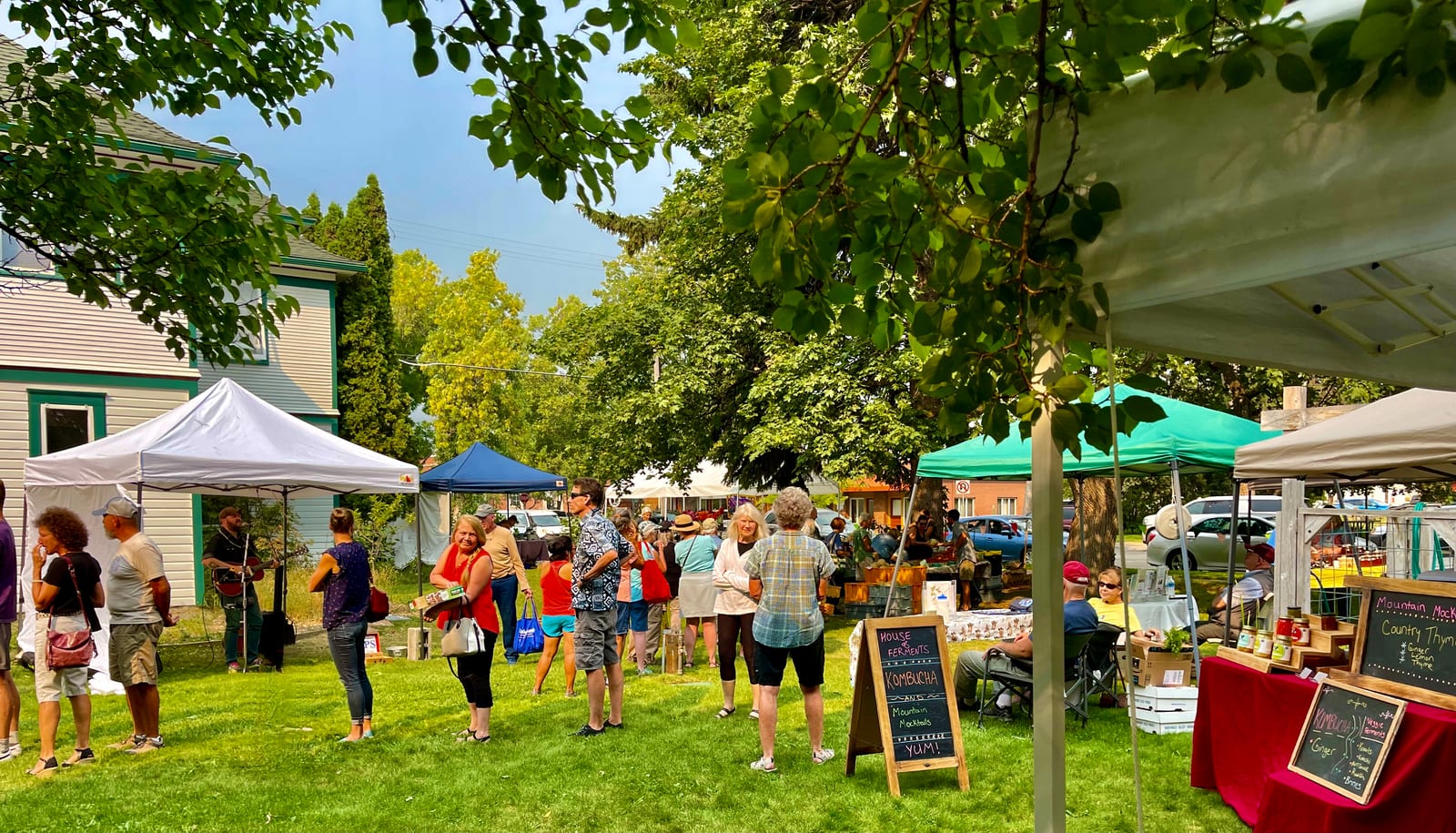 Shoppers among vendor tents on the lawn beside the O'Hara Commons building in Hamilton.