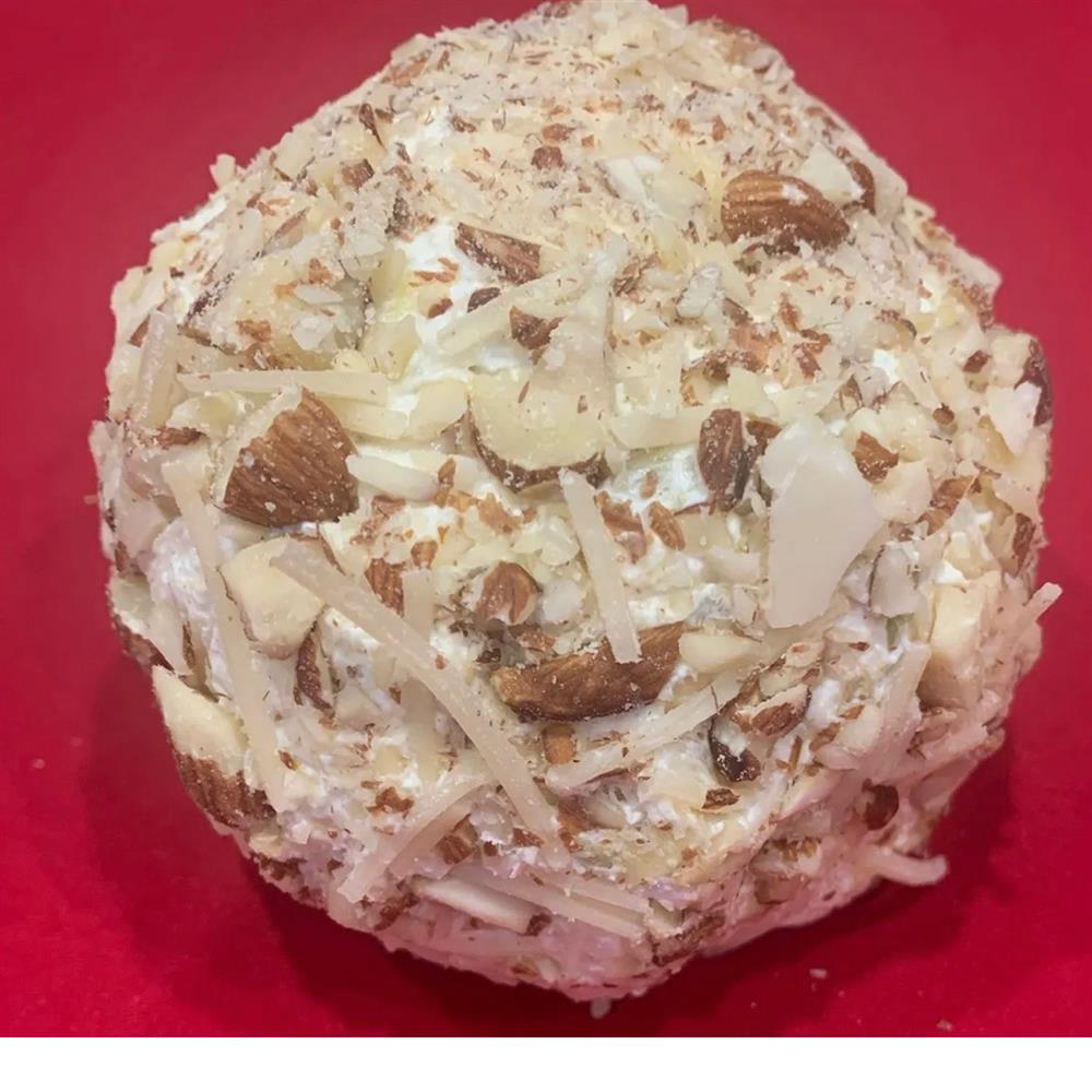 Round cheeseball coated with shredded cheese and chopped nuts