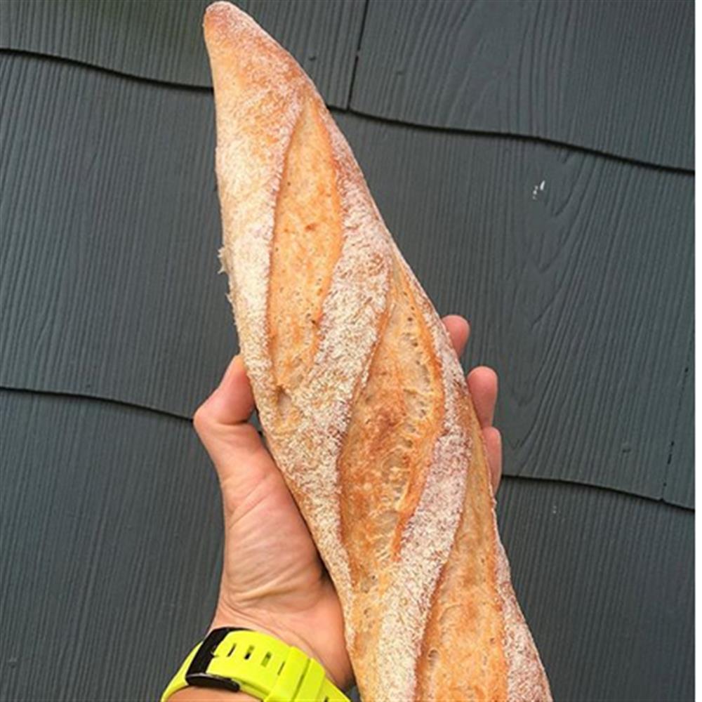 A long baguette held in one hand