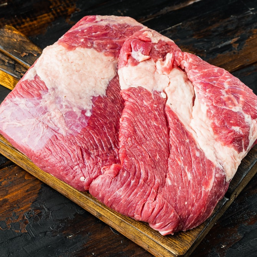 Raw beef brisket on a cutting board