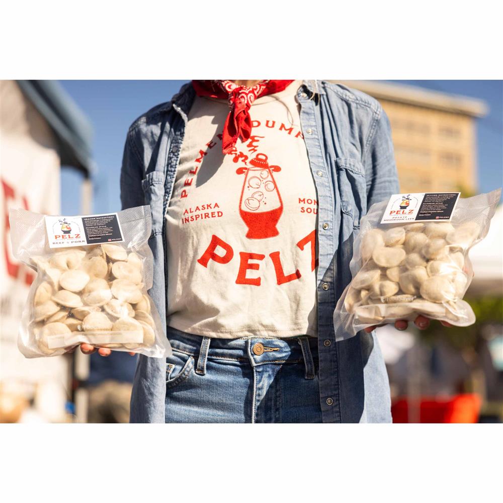 A person holding bags of Pelz dumplings.