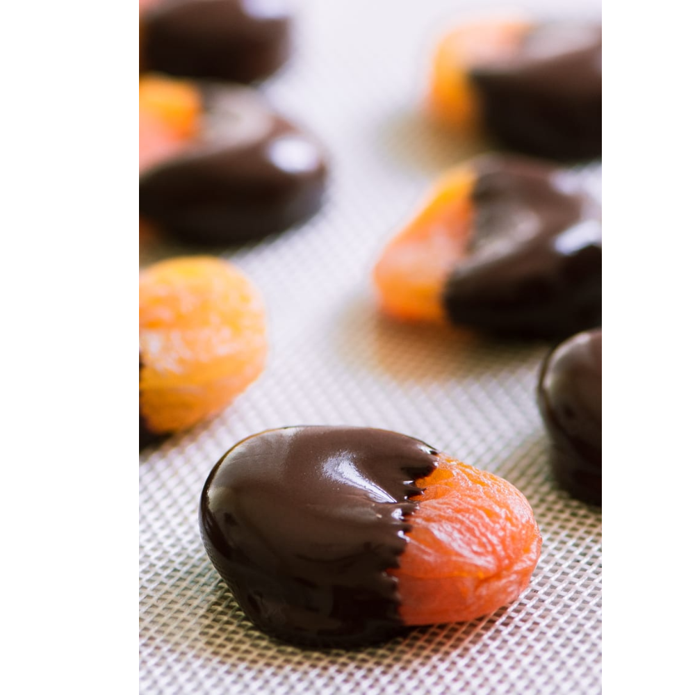 Apricots partly dipped in dark chocolate