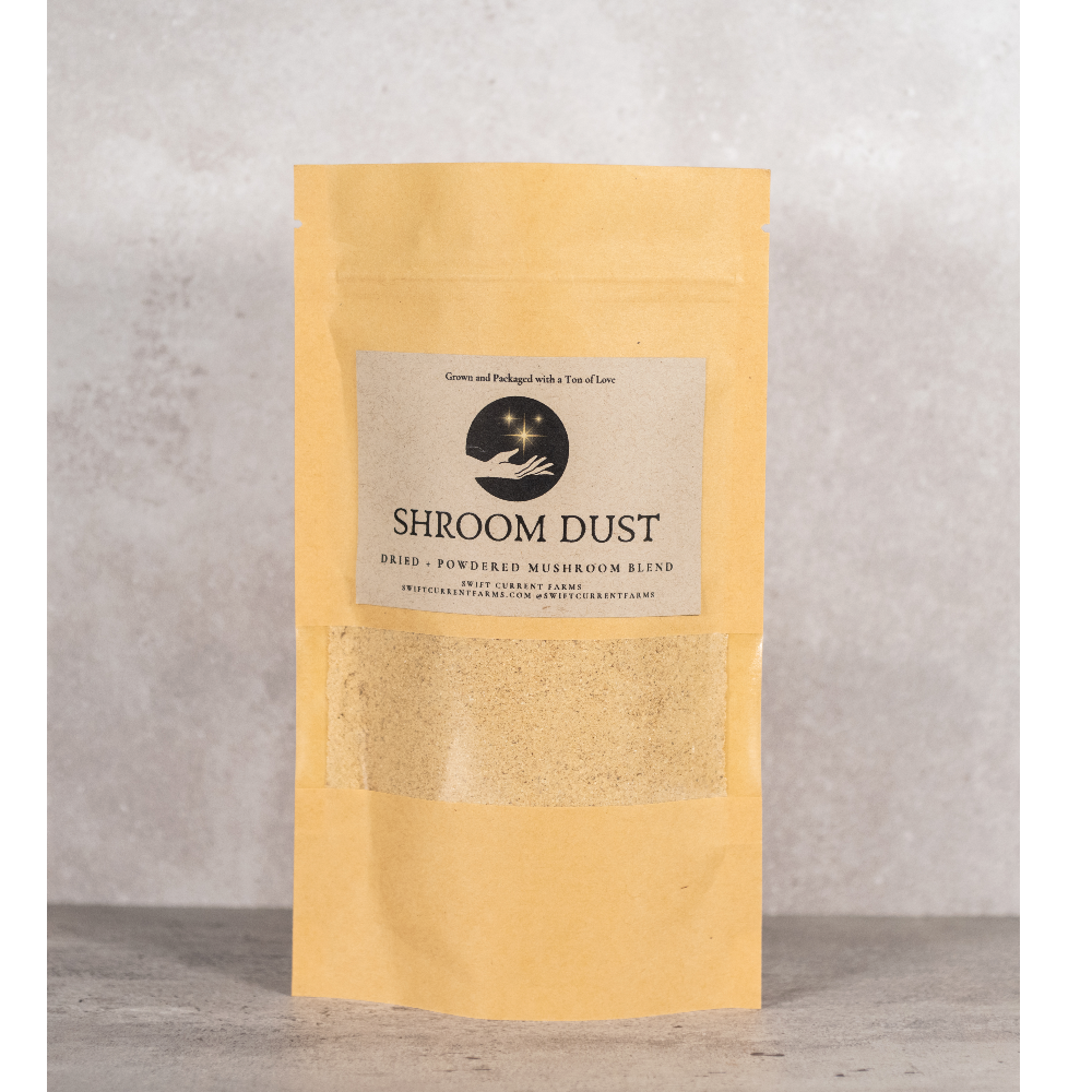 A paper pouch labeled Shroom Dust.