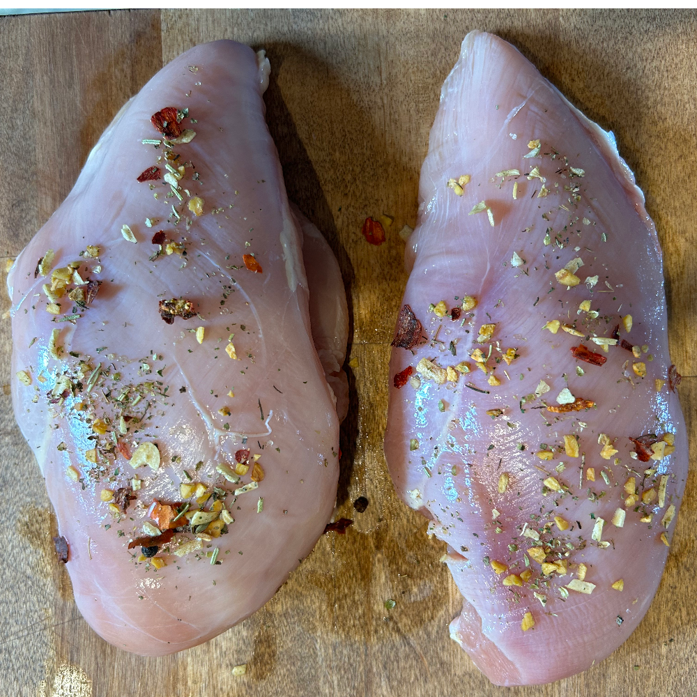 Raw chicken breasts with seasoning