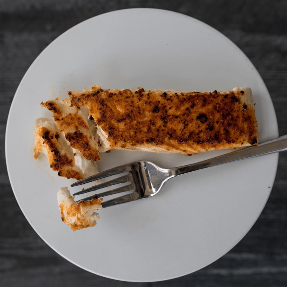 Cooked fish fillet on a white plate