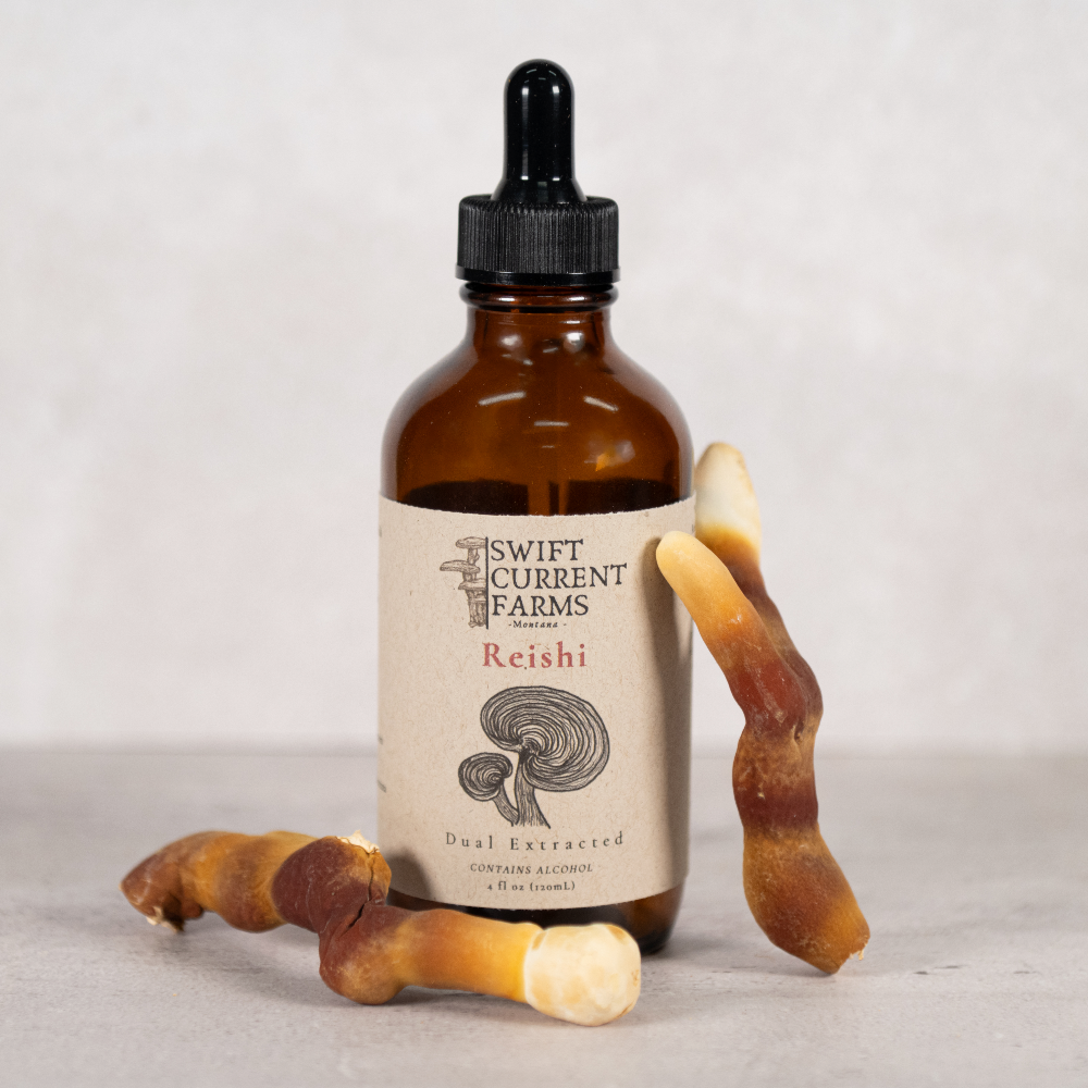 A Swift Current Farms reishi tincture bottle with reishi mushrooms.