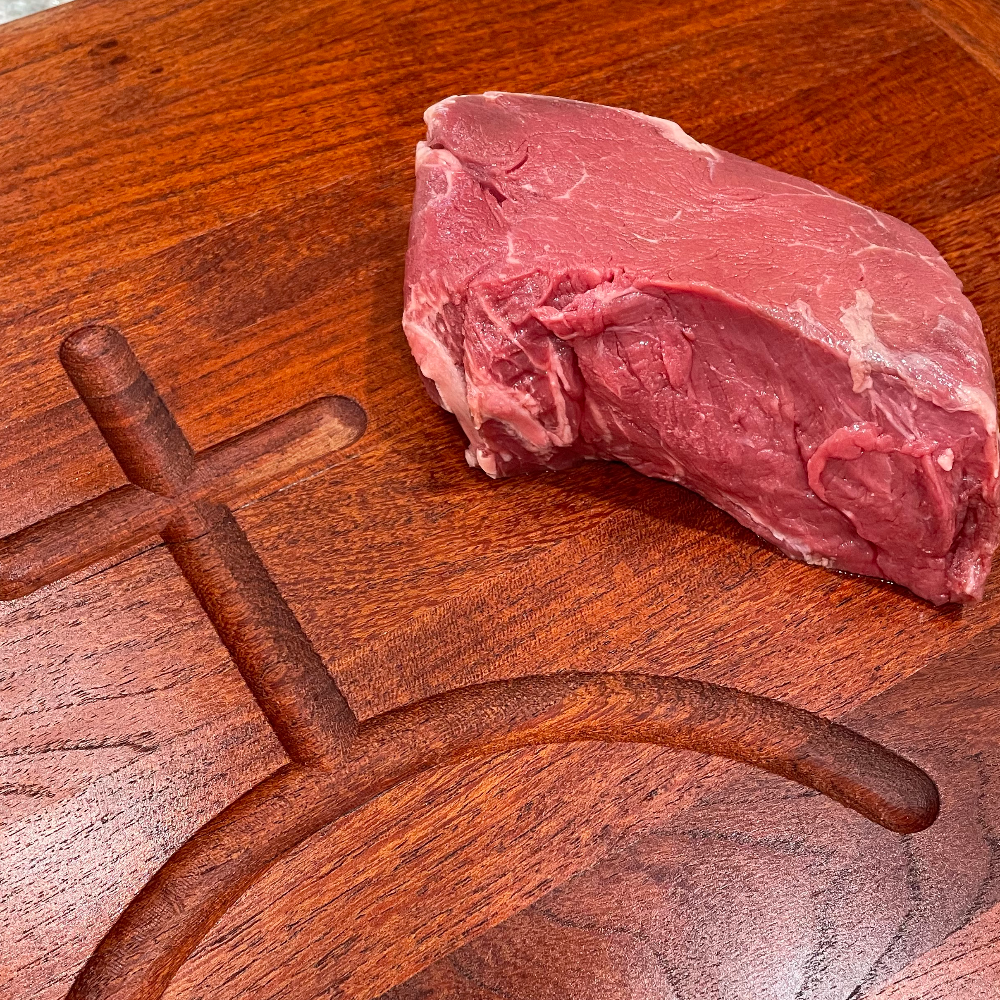 Raw beef tenderloin steak on a cutting board